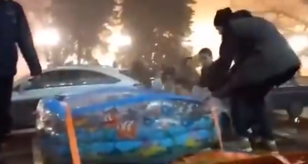 В Донецке парни ездили по городу на грузовике в бассейне с водой. Купальщиков пожурили, водителя оштрафовали